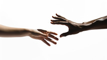 The hands of a white Caucasian and a dark-skinned African man reaching for each other. 