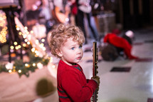 toddler boy holding a flute 