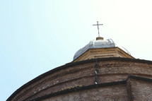 cross topper on a dome on a cathedral in Italy 