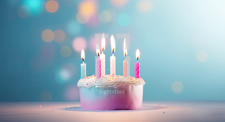 Birthday cake with burning candles on blue background with bokeh