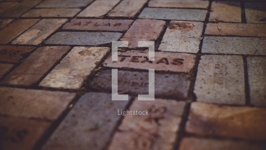 word Texas stamped in bricks 