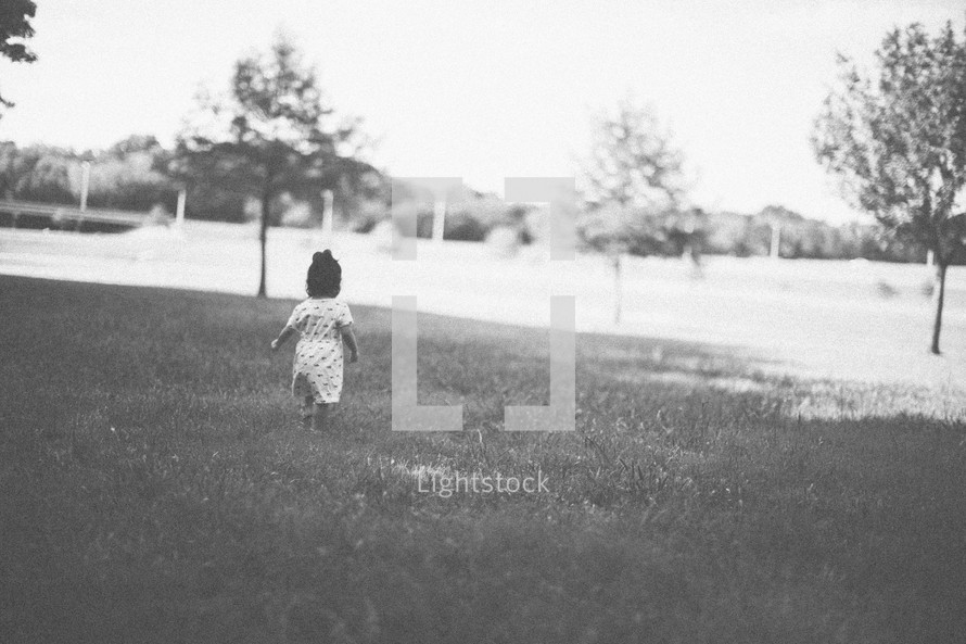 toddler girl running in the grass