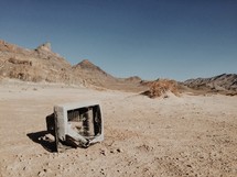 broken tv in a desert 