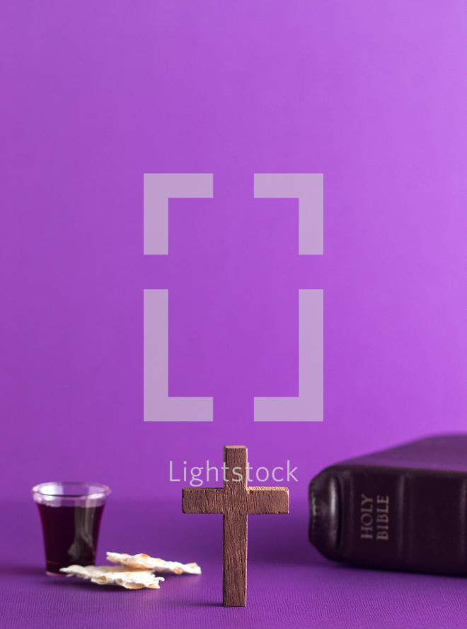 communion elements, wood cross, and Bible on purple 