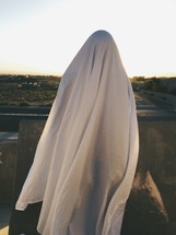 woman under a white sheet 