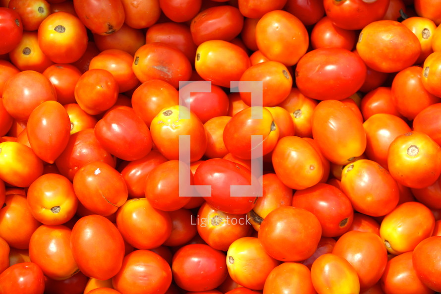 Bright red fresh tomatoes in a city vegetable market