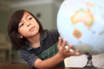 Child looking at a globe