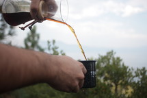 a man pouring coffee
