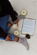 a woman in socks reading a Bible 
