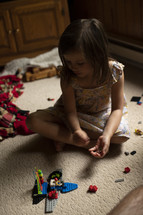 girl playing with legos 