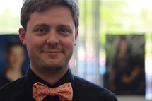 Smiling man with a bow tie.