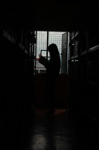 a woman looking in a storage room 