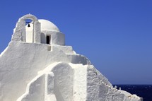 White washed Greek church overlooking the sea
