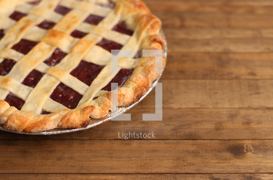 cherry pie on a wood counter 