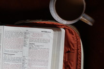 pages of a Bible and coffee mug