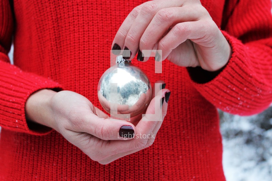 holding a Christmas ornament