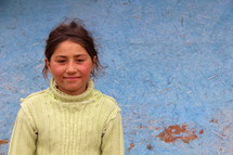 Smiling face of a Teen Romanian Gypsey girl in an old green sweater (For more like this search Ethnic Smile Face).