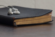 earbuds on a Bible 