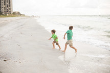 brother's running on a beach 