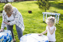 grandmother playing outdoors with her granddaughter 