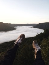 feet dangling off the side of a cliff 