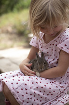 child holding a bunny 
