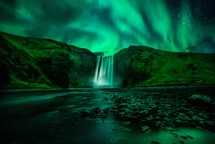 green aurora and waterfall 