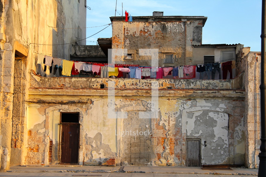 clothes drying on a clothes line across two buildings in an old building