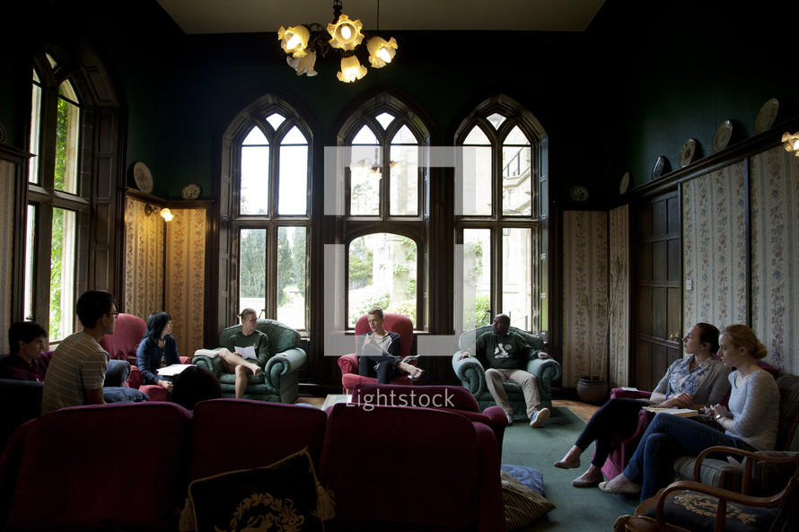 people sitting on couches having a discussion during a retreat