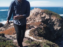 man walking on sea cliffs 