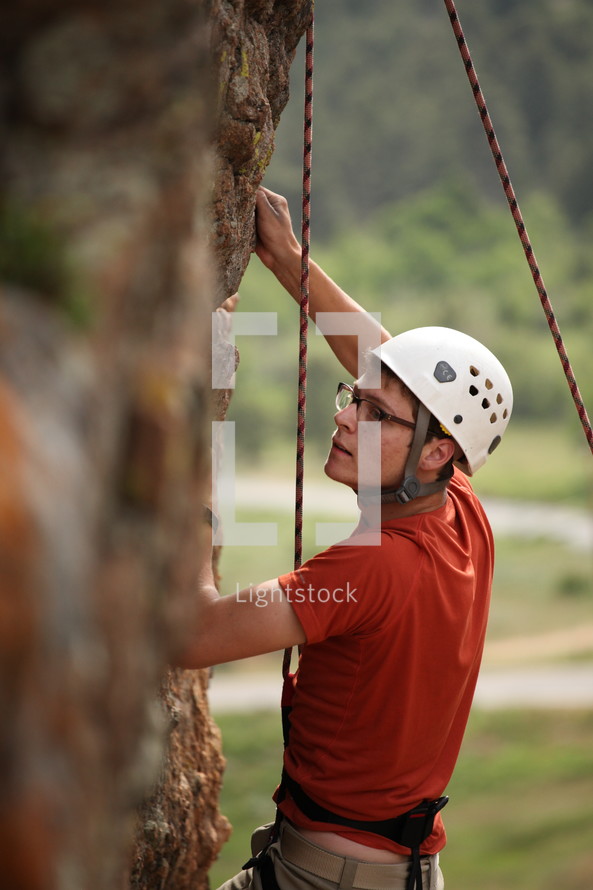 man rock climbing 