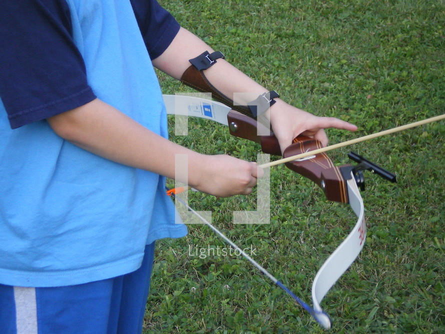 a child shooting a bow and arrow 