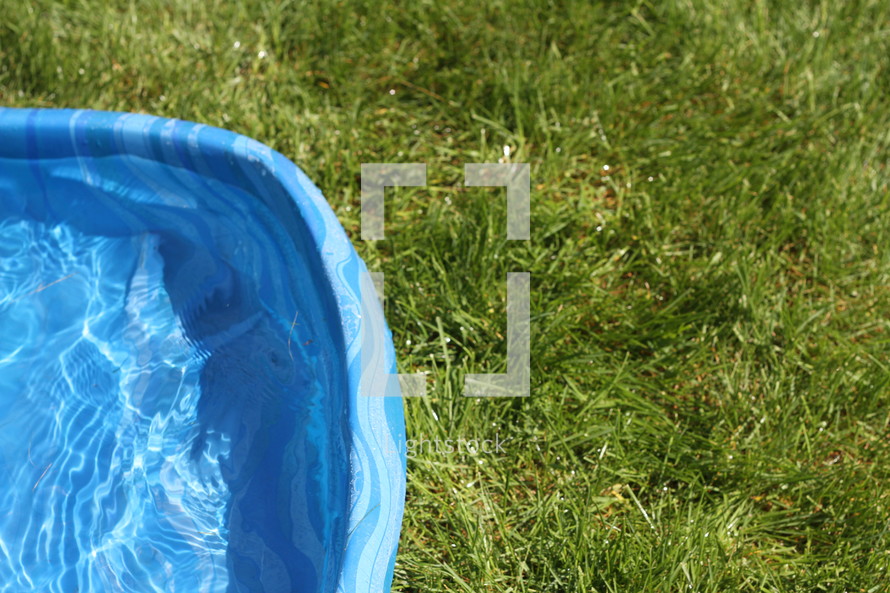 plastic pool in the grass