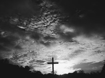 a cross under a cloudy sky 