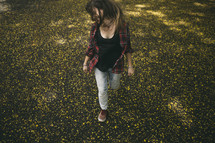 teen girl walking through a field of wildflowers 