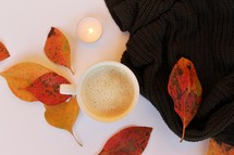 fall leaves around a latte and scarf 