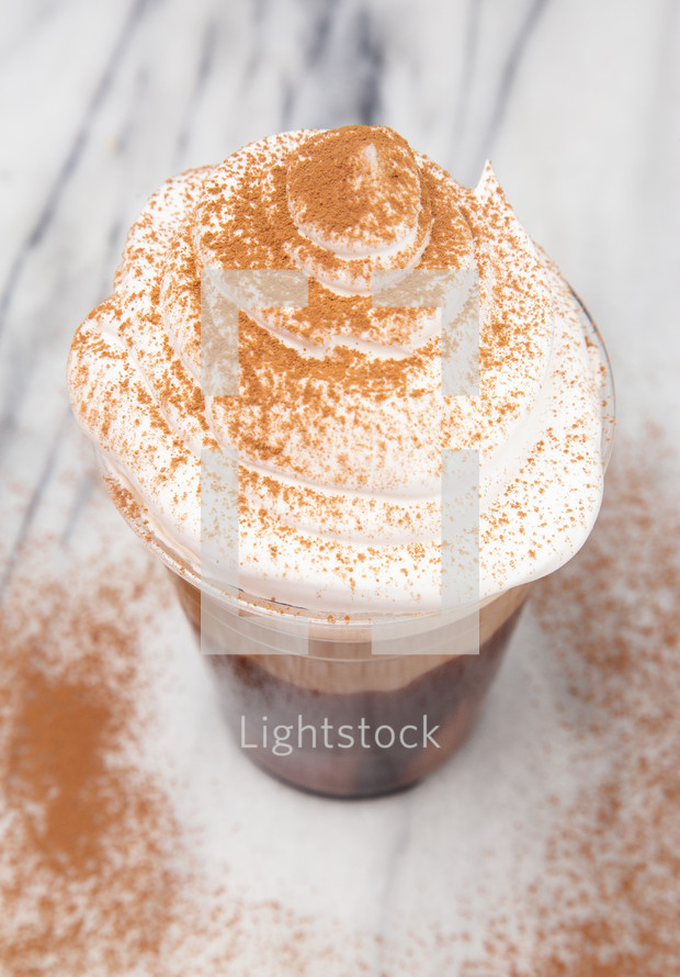 Iced Mocha in a Disposable Plastic Cup with Whipped Cream