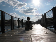 woman sitting on a pier
