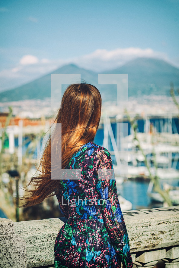 Tourist is admiring the cityscape of naples with mount vesuvius in the background