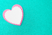 pink and white heart cutouts on teal 