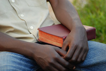 man resting with a Bible 