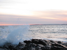 waves crashing against rocks on the shore