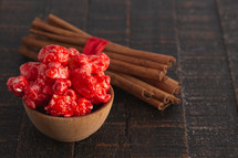 Red Cinnamon Popcorn on a Wood Background