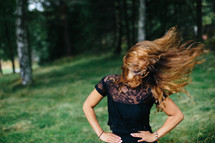 a woman tossing her hair 