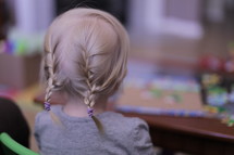 toddler girl with braided pigtails 