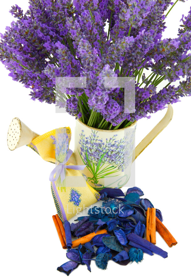 Watering can with lavender sachet on white background 