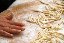 Italian pasta, strozzapreti homemade on wooden table