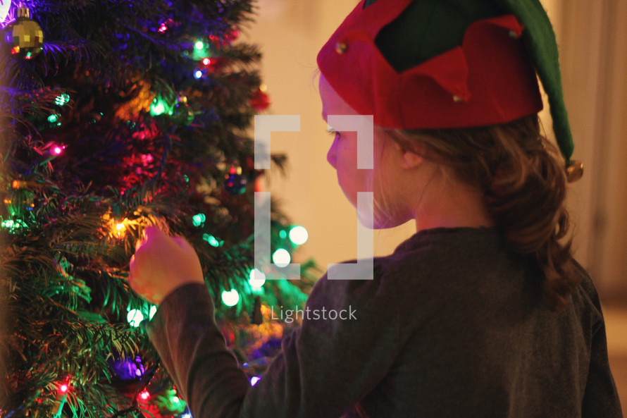 girl decorating a Christmas tree 