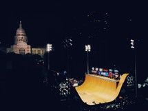 skate ramp at night and the Austin, TX capital building in the distance 