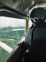 a pilot looking out a window 